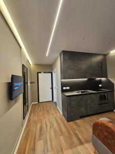 a room with a kitchen and a living room at Tirana Apartment 5 Stars in Kashari