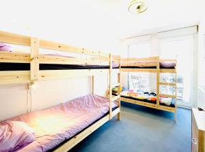 two bunk beds are in a room with a window at Bourg Palette for 10 - Parking - Netflix - Wifi - Nerf in Bussy-Saint-Georges