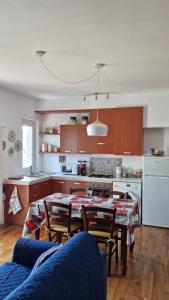 a kitchen with a table and chairs in a room at MUN Apartment - Major Unforgettable Nights in Fuipiano Valle Imagna