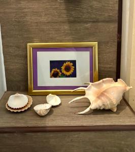 a picture of a sunflower and shells on a table at Chic & Zen in Budapest