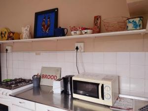 a kitchen with a microwave on a counter top at Riverview Country Inn in Van Reenen