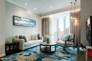 a living room with a couch and a table at Ascott Kuala Lumpur in Kuala Lumpur