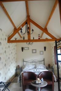 a bedroom with a bed and a table at Au Clos du Logis in Maintenay