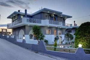 a large blue house on the side of a street at Chrysanthi Luxury Villa In Salakos, with Pool & Jacuzzi, Near Beach in Sálakos