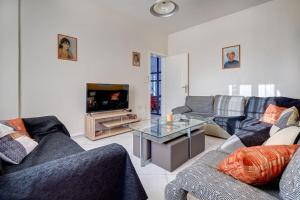 a living room with two couches and a tv at Chrysanthi Luxury Villa In Salakos, with Pool & Jacuzzi, Near Beach in Sálakos