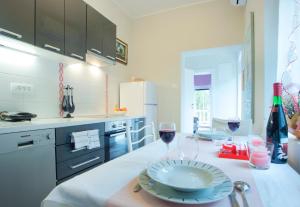 a kitchen with a table with two glasses of wine at Ferienwohnung für 2 Personen ca 32 qm in Milčetići, Kvarner Bucht Krk - b58170 in Malinska