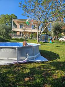 a dog sitting in a boat in the grass at Sundial house in Gouvia