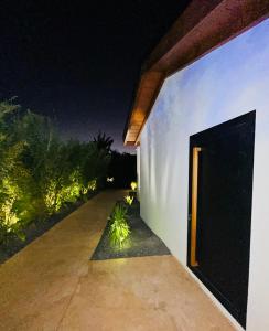 a white building with a black door at night at Tropical Lodges … Le Gosier in Le Gosier