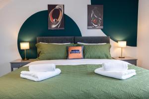 een groen bed met twee witte kussens erop bij AvenueHouse-Airport-FREEParking&WIFI in Baguley