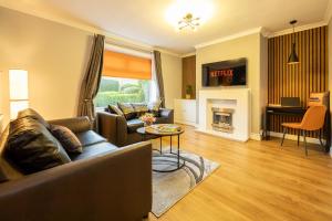 a living room with a couch and a fireplace at AvenueHouse-Airport-FREEParking&WIFI in Baguley