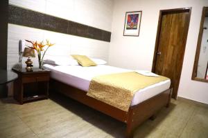 Postel nebo postele na pokoji v ubytování Hostal Macambo