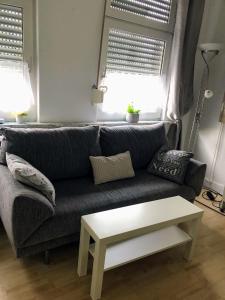 a living room with a couch and a coffee table at Stadtmitte-Iserlohn in Iserlohn