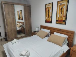 a bedroom with a large bed and a mirror at Ashkelon a front of the sea in Ashqelon