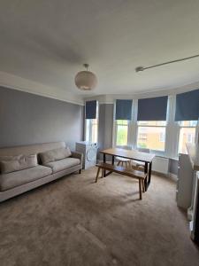 a living room with a couch and a table at Great Flat Close to Edgware Road in London