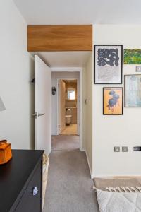 a room with a hallway leading to a bathroom at Unique Flat with Pool in Trendy Peckham Area in London