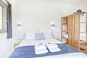 a bedroom with a bed with two towels on it at Kumquart estate- Mandarin in Aspiotádes