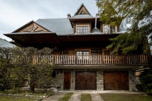 a large house with a balcony on top of it at Artist's House in Falsztyn