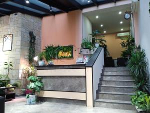 a lobby with stairs and potted plants at Sani Hotel in Tbilisi City +59 photos