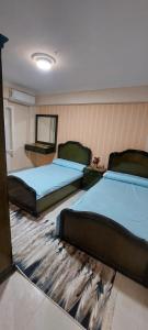 - une chambre avec 2 lits et un tapis dans l'établissement شاليه في قرية هيلو بيتش في الكيلو ٥٠, à Borg El Arab