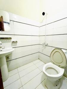 a bathroom with a toilet and a sink at Hotel Highway Link in Karachi