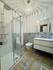 a bathroom with a shower and a sink and a toilet at Giulivi Assisi Apartments in Assisi +28 photos