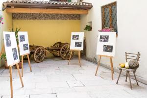 a group of photographs on stands in front of a building at Ca' dei Boieti casa vacanze in Ronzo Chienis