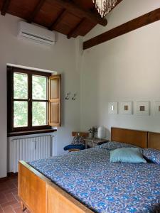 - une chambre avec un lit et une couette bleue dans l'établissement La luna e i falò, à Arezzo