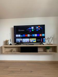 a flat screen tv sitting on a shelf at Prenoćište Šimić in Slavonski Brod