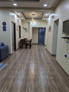 a living room with wooden floors and a dining room at Excellent Home Away from Home! in Noida
