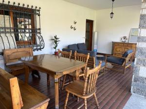 a living room with a wooden table and chairs at Bella Vita Guesthouse -parcheggio privato interno in Arona