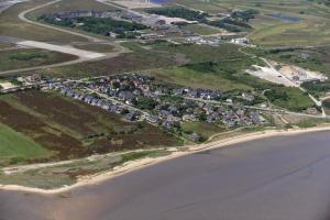 ein Luftblick auf ein Dorf neben einem Strand in der Unterkunft Ferienwohnung für 3 Personen ca 90 m in Munkmarsch, Nordfriesische Inseln Sylt in Munkmarsch