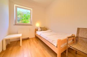 een kleine slaapkamer met een bed en een raam bij Happy Point in Krk