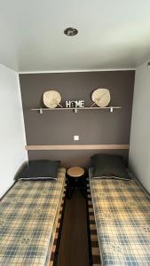 a small room with two beds and a table at Camping Sable du Midi MH 6-8 personnes in Valras-Plage