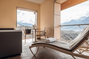 a room with a hammock in front of a large window at Hotel Villa Madruzzo in Trento