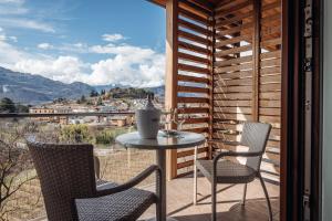 a table and chairs on a balcony with a view at Hotel Villa Madruzzo in Trento