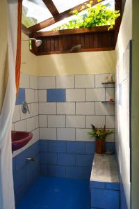 a bathroom with blue and white tiles and a sink at Chalet at the river's edge in Dos Brazos