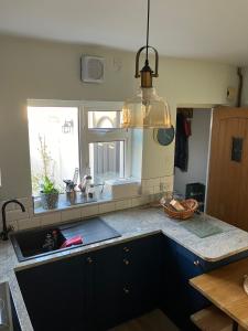 a kitchen with a sink and a counter top at Belmont Gem in Knaresborough