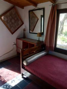 a bedroom with a large bed and a window at Houni House in Agriovótanon