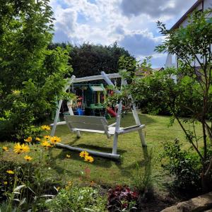 a helicopter in a garden with flowers at Apartament Poranek in Grzybowo