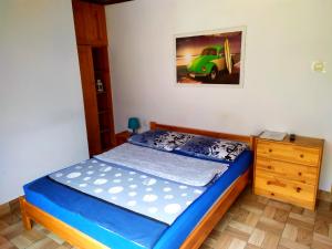 a small bedroom with a bed and a dresser at Noclegi Relax in Ruciane-Nida