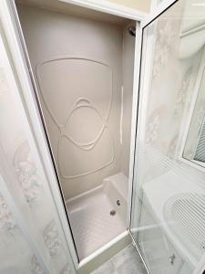 a walkin shower with a glass door at Golden Anchor 8b9 Caravan Park Holiday Home in Chapel Saint Leonards