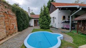 a swimming pool in the yard of a house at Apartmán Modré z nebe in Němčičky