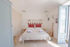 Postel nebo postele na pokoji v ubytování Trullo Dimora Podere Papilio + 37 fotografií