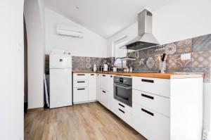 a kitchen with white cabinets and a sink at Schöne Wohnung in Novigrad mit privatem Parkplatz in Karpinjan