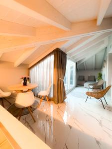 an attic room with a table and chairs and a bed at Camere Amely in Sanremo