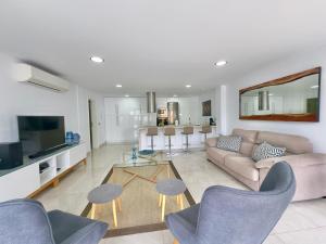 a living room with a couch and a table at Apartamento Tenerife Vista Bella in Santa Cruz de Tenerife
