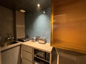 a kitchen with a counter top with a microwave at EMPIRE PLATINUM SUITES in New Delhi