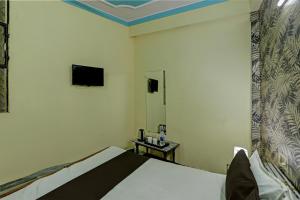 En eller flere senger på et rom på OYO Flagship HOTEL RAJENDRA PALACE