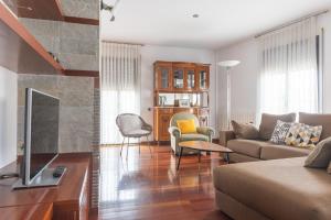 a living room with a couch and a fireplace at Mazi Apartments Colón in Vic