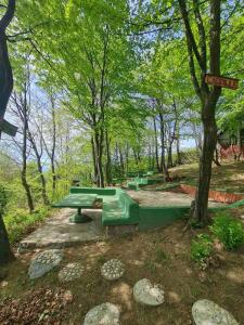 a group of picnic tables in a park at Cabin 4 Hill Station in Sarajevo